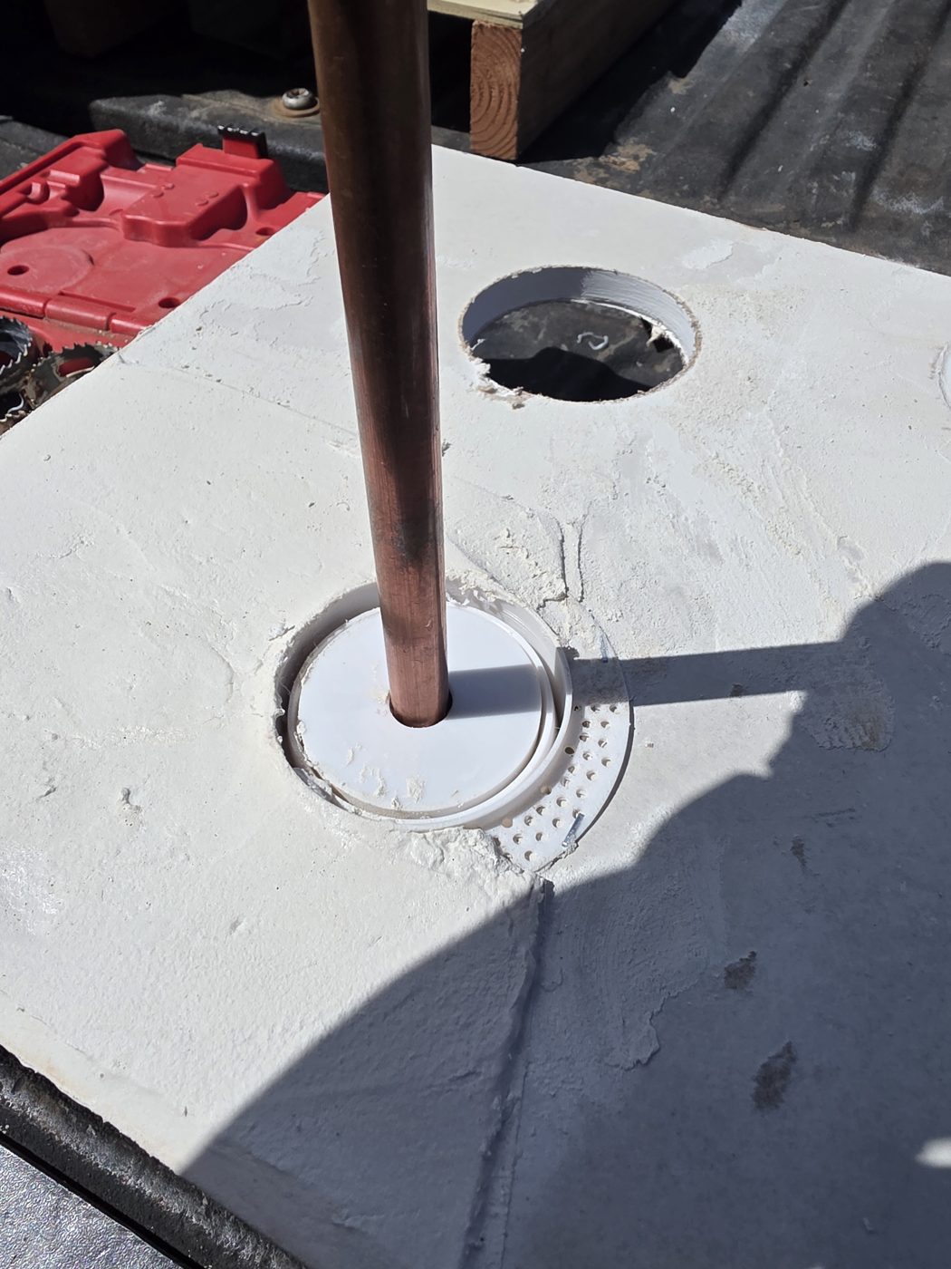 Copper pipe passing through the Stucco Expansion Joint Ring in a stucco panel