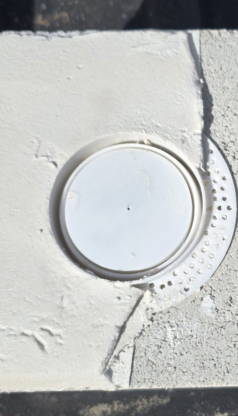 Stucco Expansion Joint Ring set in a stucco panel, center not yet drilled